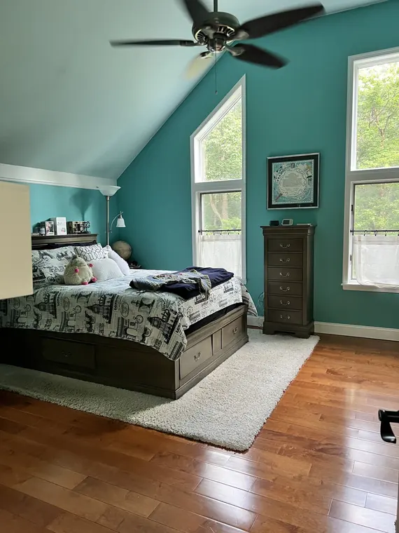 Freshly cleaned bedroom with neatly arranged bedding and polished floor