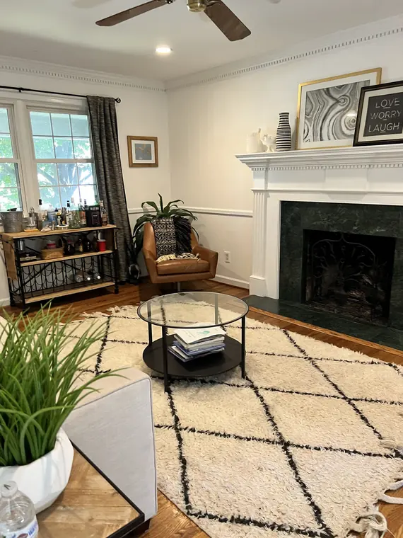 Tidy living room with clean fireplace area and rug