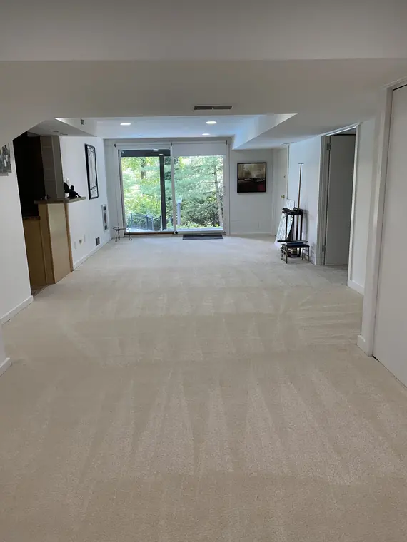 Empty carpeted room prepared for a new resident